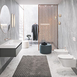 Ein modernes Badezimmer mit grauen Marmorwänden, rundem Spiegel, schwebendem Waschbecken und stilvoller Trennwand. Dezente Beleuchtung rundet das Design ab. Ein modernes Badezimmer mit grauen Marmorwänden, rundem Spiegel, schwebendem Waschbecken und stilvoller Trennwand. Dezente Beleuchtung rundet das Design ab.